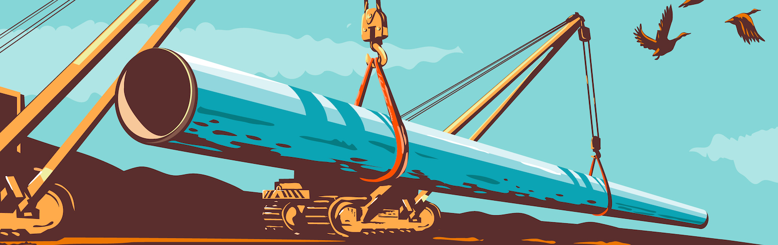 Heavy machinery lays a new section of pipeline